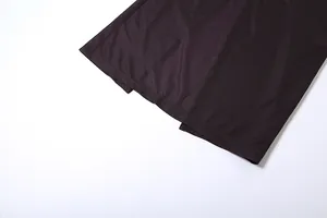 Close-up detail of the high-quality stitching and smooth hem on a dark purple dress.