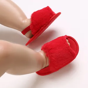 Detail shot of soft red fuzzy baby girl sandals featuring a secure elastic back strap