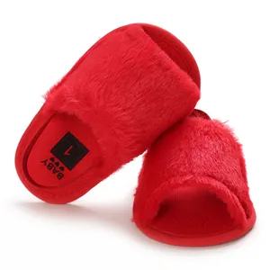 Detailed view of red furry baby sandals with soft plush texture and anti-slip sole