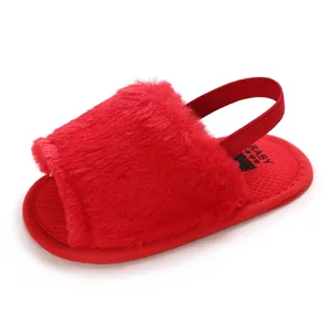 Cozy red fuzzy baby sandals featuring an elastic back strap and non-slip soles for pre-walkers.