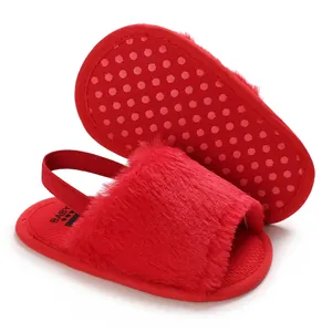 Detailed view of red fluffy baby sandals with soft fur texture and non-slip sole
