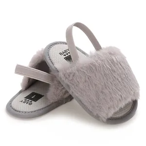 Detailed view of grey fuzzy infant sandals with elastic back strap and soft insole.