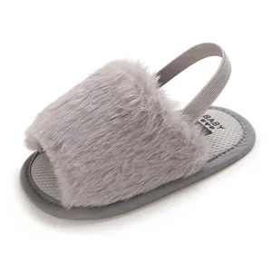 Detail shot of grey fuzzy baby sandals with soft elastic back strap.