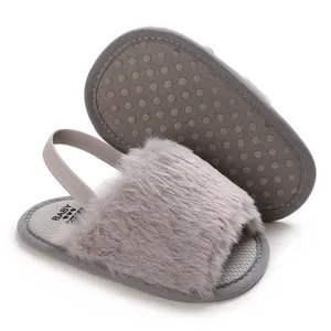 Detailed macro view of grey fluffy baby sandals featuring non-slip silicone sole dots.