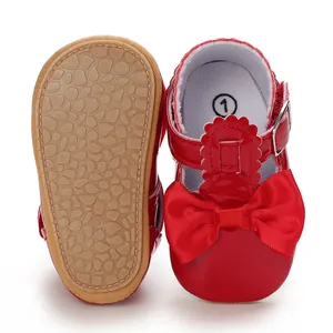 Detail view of red baby princess shoes showing non-slip soft sole and bow