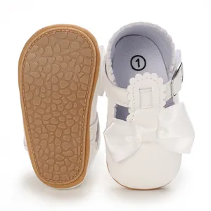 Adorable white baby princess shoes featuring a satin bow and soft non-slip textured sole