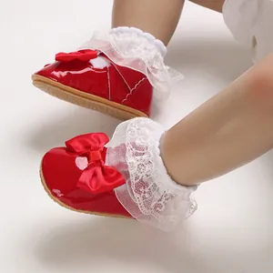 Elegant red baby girl princess shoes with decorative bow and white lace ruffle socks