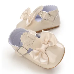 Detailed view of beige baby princess shoes featuring a large silk bow and buckle strap