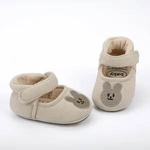 Detailed view of beige baby walker shoes featuring a cute rabbit embroidery design