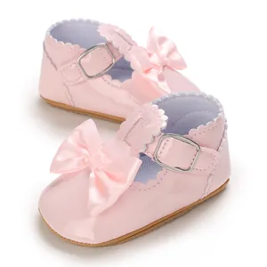 Adorable pink patent leather baby girl Mary Jane shoes with ribbon bow and soft sole