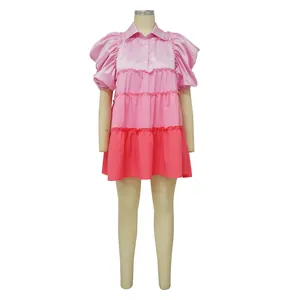 Detailed view of pink color-block satin tiered dress with puff sleeves on a white background
