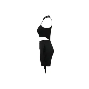 Side view of a chic black sleeveless crop top and mini skirt set with fringe details.