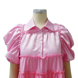 Elegant pink satin dress featuring delicate ruffled tiers and stylish puff sleeves detail