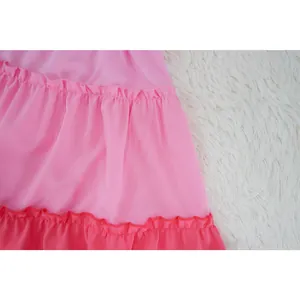 Detailed close-up of pink and red tiered ruffles on a lightweight chiffon dress skirt.