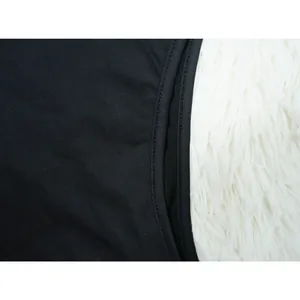 Macro view of the high-quality black fabric texture and neat double-stitch hem detail