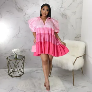 Detail showing the vibrant tiered pink gradient of the satin puff sleeve mini dress.