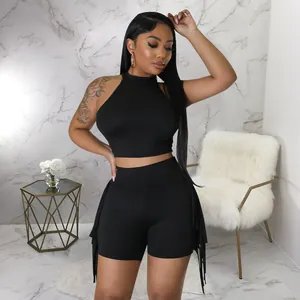 Two-piece set featuring a black sleeveless halter crop top and matching fringe detail shorts