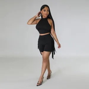 Stylish black sleeveless two-piece set with fringe detailing shown on fashion model