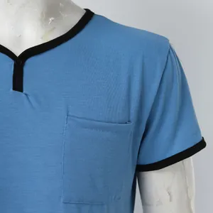 Close-up of blue men's pajama shirt featuring black contrast trim and chest pocket