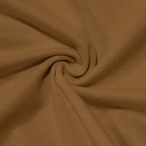 Close-up macro view of soft brown jersey knit fabric texture with natural deep folds