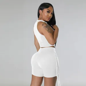 Detailed back view of a stylish white sleeveless crop top and fringe shorts two-piece set