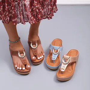 Tongs compensées pour femmes avec design ajouré au laser et anneau métallique chic.