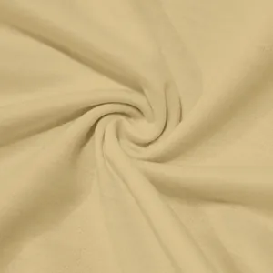 Close-up of light beige knit fabric showing soft texture and fine grain detail macro view