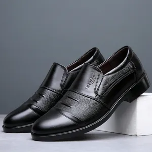 Macro detail of black leather men's business shoes with textured finish and embossed logo
