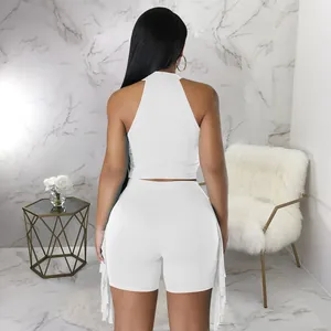 Back view of a chic white two-piece set featuring a sleeveless top and fringe shorts
