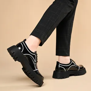 Black patent leather platform shoes for men with white trim and chunky lug sole