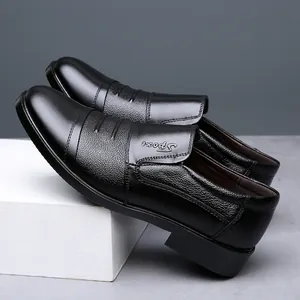 Detailed side view of black leather dress shoes showing texture and fine stitch details.
