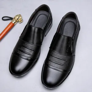 Close-up of black genuine leather men's business dress shoes with textured paneling