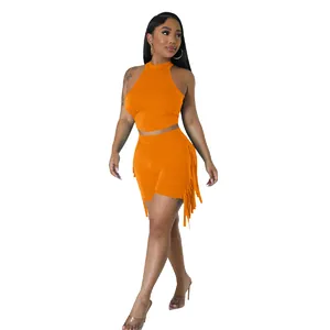 Sleeveless orange two-piece set featuring a high neck top and shorts with fringe details