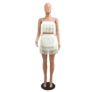 Full view of white fringe two-piece set featuring camisole crop top and mini skirt