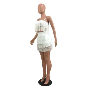 Side view of a white fringe two-piece set featuring a crop top and a mini skirt.