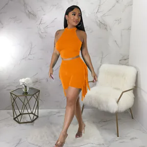 Vibrant orange two-piece set featuring halter neck crop top and shorts with fringe detail.