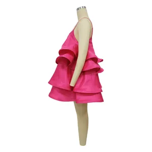 Side view of hot pink satin ruffled mini dress showing tiered puff layers on mannequin
