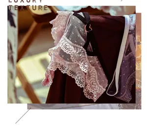Elegant detail showing pink floral lace panties with a heart-shaped metal buckle