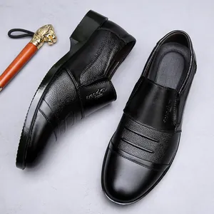 Detail view of black men's genuine leather business shoes showing texture and logo
