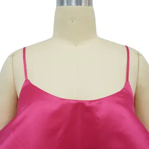 Close-up of pink satin dress showing U-neckline and delicate spaghetti straps