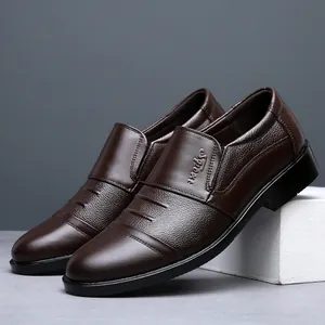 Detailed side view of men's dark brown leather slip-on dress shoes with embossed Sport logo.