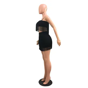 Side view of black two-piece set featuring dense fringe crop top and mini skirt