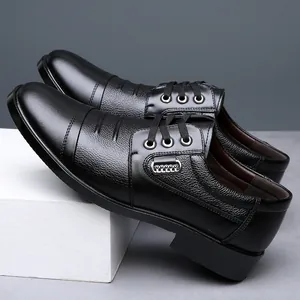 Elegant detail of men's black leather dress shoes with soft cap-toe design and laces.