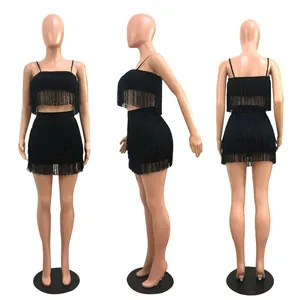 Detail view of a black tassel crop top and mini skirt set on a mannequin from three angles.