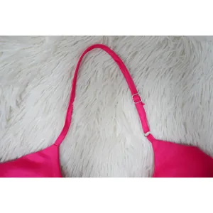 Detailed macro view of the adjustable hot pink satin shoulder strap on a camisole dress
