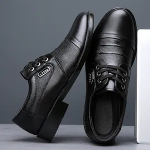 Macro detail shot of men's black leather business shoes showing texture and lace-up design
