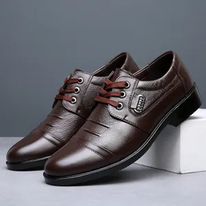 Detail view of brown men's business casual leather shoes with textured lace-up design