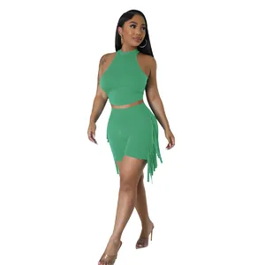 Full body view of women's green sleeveless two-piece set with side fringe on shorts