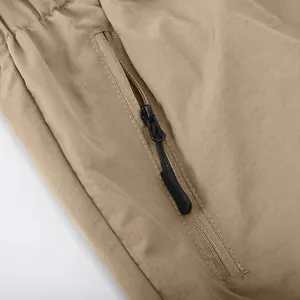 Detailed macro view of durable khaki cargo shorts with a secure side zipper pocket