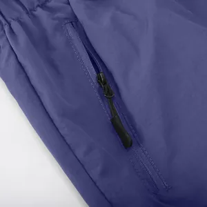 Close-up of black zipper pocket detail on men's purple outdoor cargo shorts